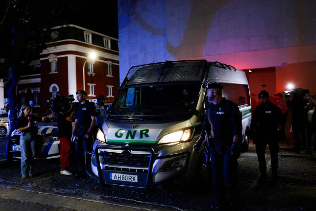 A vehicle of the National Gendarmerie of Portugal (GNR) with Marine Rousseau and Marc Ballabriga (not pictured) leaves the Setubal courthouse, suspected of abandoning two children, in Setubal, Portugal, on May 23, 2026. The two French children, aged four and five, who were found alone by a roadside, have been placed with a foster family in Portugal while awaiting their return to France, the court of Setubal announced today. (Photo by FILIPE AMORIM / AFP)