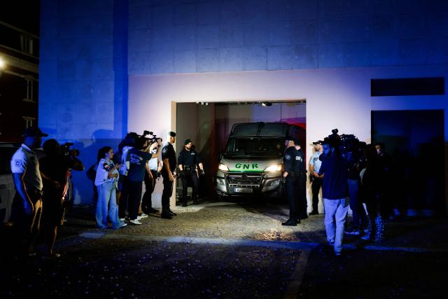 A vehicle of the National Gendarmerie of Portugal (GNR) with Marine Rousseau and Marc Ballabriga (not pictured) leaves the Setubal courthouse, suspected of abandoning two children, in Setubal, Portugal, on May 23, 2026. The two French children, aged four and five, who were found alone by a roadside, have been placed with a foster family in Portugal while awaiting their return to France, the court of Setubal announced today. (Photo by FILIPE AMORIM / AFP)