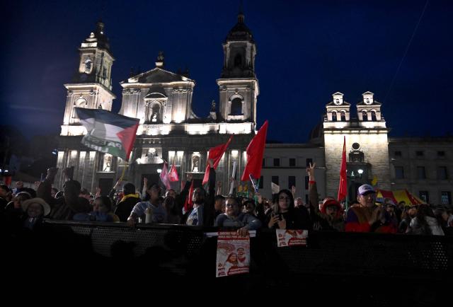 Supporters of Colombia's ruling party leftist presidential candidate Ivan Cepeda wait for his speech during a campaign rally at Plaza Bolivar in Bogota on May 22, 2026. Colombia will hold presidential elections on May 31. (Photo by Raul ARBOLEDA / AFP)