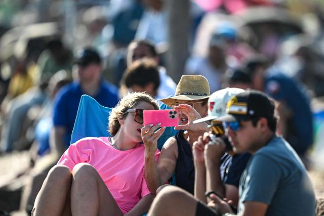 People gather in South Padre Island, Texas, to watch the launch of SpaceX's Starship 39 rocket from Starbase, on May 22, 2026. Elon Musk's SpaceX on May 22 launched its latest Starship, sending the mammoth rocket soaring into the Texas skies after its initial attempt was scrubbed due to technical issues. The Starship spacecraft and Super Heavy rocket booster appeared to separate as expected, but the company's spokesperson Dan Huot said on the livestream that the booster did not complete a burn necessary to steer itself to a controlled landing, meaning it likely can't make a precision touchdown as hoped. (Photo by RONALDO SCHEMIDT / AFP)