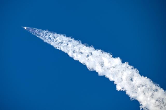 SpaceX's Starship 39 rocket launches from Starbase during the 12th test flight as seen from South Padre Island, Texas, on May 22, 2026. Elon Musk's SpaceX on May 22 launched its latest Starship, sending the mammoth rocket soaring into the Texas skies after its initial attempt was scrubbed due to technical issues. The Starship spacecraft and Super Heavy rocket booster appeared to separate as expected, but the company's spokesperson Dan Huot said on the livestream that the booster did not complete a burn necessary to steer itself to a controlled landing, meaning it likely can't make a precision touchdown as hoped. (Photo by RONALDO SCHEMIDT / AFP)