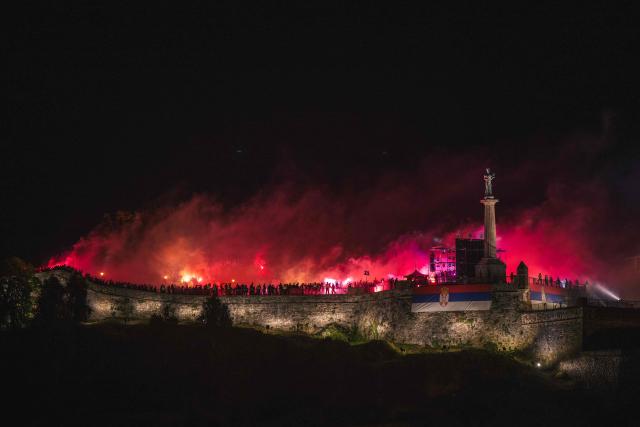 Supporters of FK Crvena Zvezda (Red Star) light flares as they celebrate the club’s Serbian SuperLiga and Serbian Cup triumphs at the medieval Kalemegdan Fortress in Belgrade, on May 23, 2026. (Photo by Andrej ISAKOVIC / AFP)