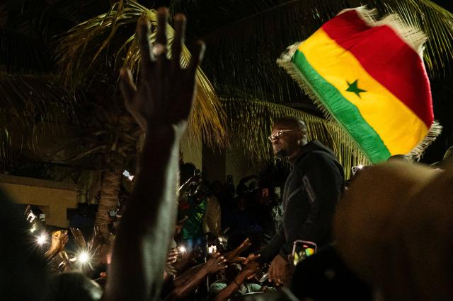 Ousmane Sonko is cheered by supporters as he arrives to his home in Dakar on May 23, 2026 following his dismissal as Senegal's prime minister. Senegal President Bassirou Diomaye Faye on May 22 sacked Prime Minister Ousmane Sonko and dissolved the government after months of tensions, deepening a crisis in the debt-laden west African nation. The shock announcement was made on state television in a decree read out by presidential aide Oumar Samba Ba, who said Faye "has ended the duties of Ousmane Sonko...  and consequently those of the ministers and secretaries of state who are members of the government". (Photo by SEYLLOU / AFP)