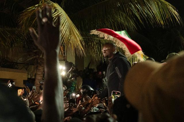 Ousmane Sonko is cheered by supporters as he arrives to his home in Dakar on May 23, 2026 following his dismissal as Senegal's prime minister. Senegal President Bassirou Diomaye Faye on May 22 sacked Prime Minister Ousmane Sonko and dissolved the government after months of tensions, deepening a crisis in the debt-laden west African nation. The shock announcement was made on state television in a decree read out by presidential aide Oumar Samba Ba, who said Faye "has ended the duties of Ousmane Sonko...  and consequently those of the ministers and secretaries of state who are members of the government". (Photo by SEYLLOU / AFP)