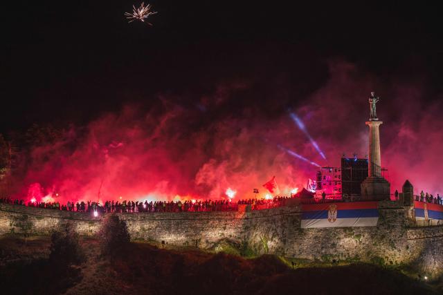 Supporters of FK Crvena Zvezda (Red Star) light flares as they celebrate the club’s Serbian SuperLiga and Serbian Cup triumphs at the medieval Kalemegdan Fortress in Belgrade, on May 23, 2026. (Photo by Andrej ISAKOVIC / AFP)
