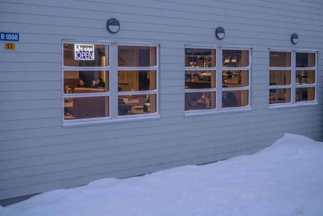 Locals and tourists are visible behind the windows of the Nuka cafй as the streets lie under snow, in Ilulissat, Greenland, on March 19, 2026. Around 1,200 Filipinos are settled in Greenland, which has 57,000 inhabitants, making them the largest foreign diaspora in this Danish territory. According to Greenland’s employers’ organisations, 5 to 6% of workers in the Arctic territory are now Asian, drawn by expanding sectors such as tourism. (Photo by Florent VERGNES / AFP)