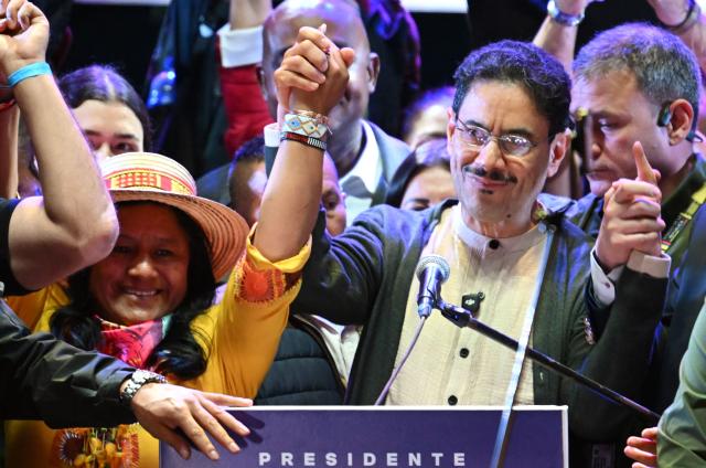 Colombia's presidential candidate from the leftist ruling party Ivan Cepeda rises his arms next to his vice-presidential formula Aida Quilcue during a campaign rally at Plaza Bolivar in Bogota on May 22, 2026. (Photo by Raul ARBOLEDA / AFP)