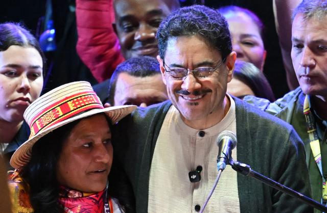 Colombia's presidential candidate from the leftist ruling party Ivan Cepeda embraces his vice-presidential formula Aida Quilcue during a campaign rally at Plaza Bolivar in Bogota on May 22, 2026. (Photo by Raul ARBOLEDA / AFP)