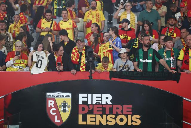 Lens RC supporters celebrate as they greet the victorious players after Lens RC won the French Cup final football match against Nice OGC in Lens, northern France, on May 23, 2026. (Photo by FRANCK FIFE / AFP)