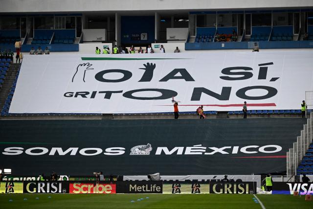 A giant banner that reads in Spanish: "The Wave YES, Shout NO," is displayed on the benches before the friendly football match between Mexico and Ghana at the Cuauhtemoc Stadium in Puebla, Mexico, on May 22, 2026. The Mexican Football Federation (FMF) announced on May 22 that it had been sanctioned by FIFA for homophobic chants heard during the Mexican national team’s matches against Ecuador and Paraguay in October and November 2025. (Photo by Alfredo ESTRELLA / AFP)