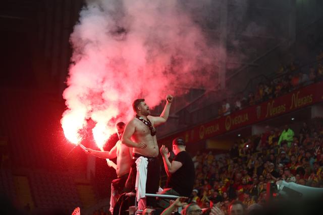 Lens RC supporters celebrate as they greet the victorious players after Lens RC won the French Cup final football match against Nice OGC in Lens, northern France, on May 22, 2026. (Photo by FRANCK FIFE / AFP)