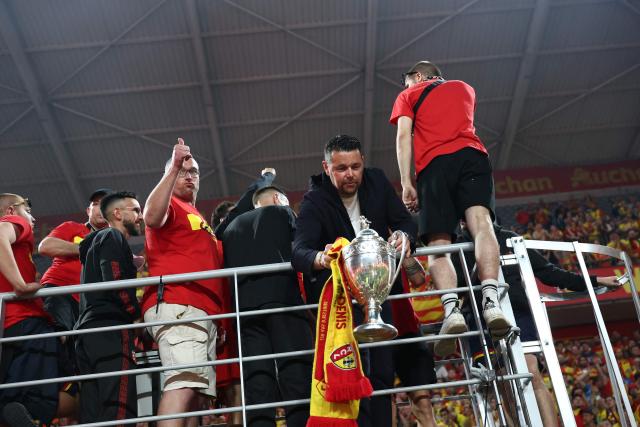 Lens' French head coach Pierre Sage holds the French Cup trophy during a celebration after Lens RC won the French Cup final football match against Nice OGC in Lens, northern France, on May 22, 2026. (Photo by FRANCK FIFE / AFP)