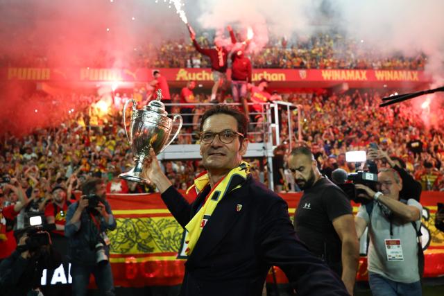 Lens RC president Joseph Oughourlian celebrates with the French Cup trophy after Lens RC won the French Cup final football match against Nice OGC in Lens, northern France, on May 22, 2026. (Photo by FRANCK FIFE / AFP)