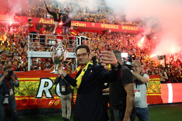 Lens RC president Joseph Oughourlian celebrates with the French Cup trophy after Lens RC won the French Cup final football match against Nice OGC in Lens, northern France, on May 22, 2026. (Photo by FRANCK FIFE / AFP)