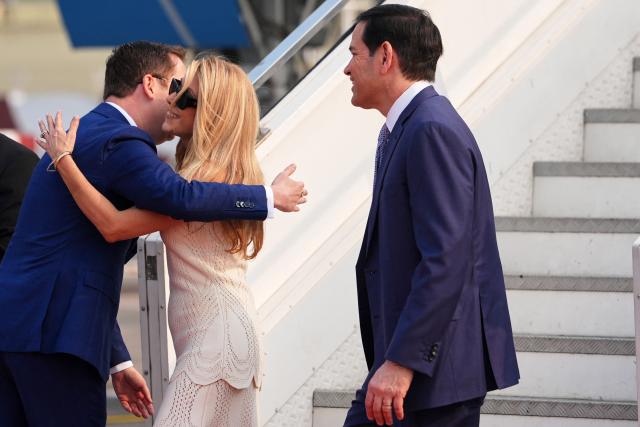 US Secretary of State Marco Rubio (R) looks on after disembarking his plane as the US Ambassador to India Sergio Gor (L) greets his wife Jeanette at Netaji Subhash Chandra Bose International Airport in Kolkata on May 23, 2026. Rubio arrived May 23 on his first trip to India where he will meet Prime Minister Narendra Modi on the heels of US diplomacy with China. (Photo by Julia Demaree Nikhinson / POOL / AFP)