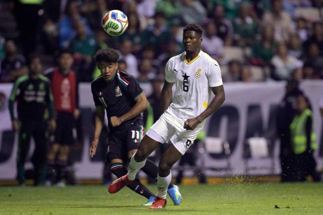 Mexico's forward #11 Guillermo Martinez and Ghana's defender #06 Terry Yegbe fight for the ball during a friendly football match between Mexico and Ghana at the Cuauhtemoc Stadium in Puebla, Mexico, on May 22, 2026. (Photo by Alfredo ESTRELLA / AFP)