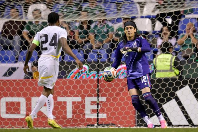 Mexico's goalkeeper #12 Carlos Acevedo holds the ball in front of Ghana's forward #24 Jerry Afriyie during a friendly football match between Mexico and Ghana at the Cuauhtemoc Stadium in Puebla, Mexico, on May 22, 2026. (Photo by Alfredo ESTRELLA / AFP)