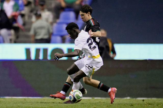 Ghana's midfielder #22 Abdul Aziz Issah and Mexico's defender #20 Mateo Chavez fight for the ball during a friendly football match between Mexico and Ghana at the Cuauhtemoc Stadium in Puebla, Mexico, on May 22, 2026. (Photo by Alfredo ESTRELLA / AFP)