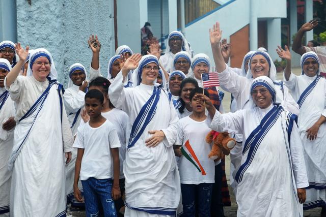 Sisters of Nirmala Shishu Bhavan children’s home of the Missionaries of Charity wave at the cavalcade of US Secretary of State Marco Rubio in Kolkata on May 23, 2026. (Photo by Julia Demaree Nikhinson / POOL / AFP)