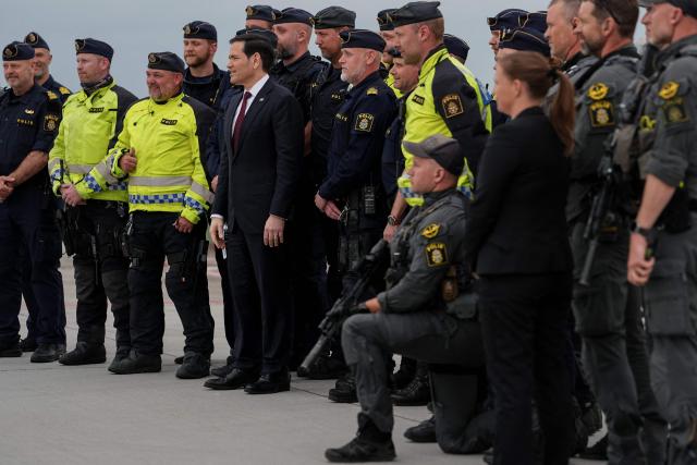 US Secretary of State Marco Rubio (C) poses for a photo with Swedish police officers before boarding his plane at Malmo Airport in Malmo-Sturup on May 22, 2026, before his departure for India. (Photo by Julia Demaree Nikhinson / POOL / AFP)