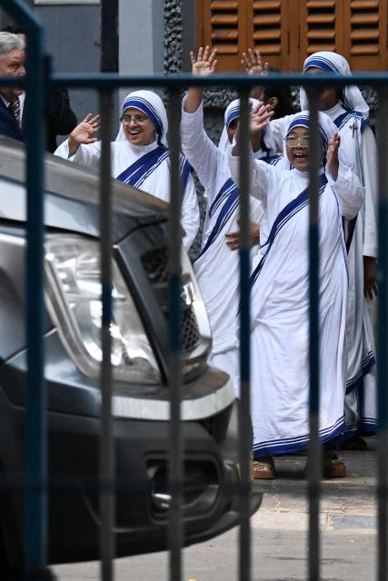Sisters of the Missionaries of Charity wave to US Secretary of State Marco Rubio after his visit to the international headquarters of Missionaries of Charity known as the "Mother House" in Kolkata on May 23, 2023. (Photo by Dibyangshu SARKAR / AFP)