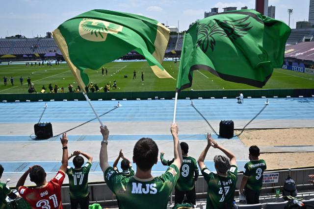Japan's Tokyo Verdy Beleza supporters cheer ahead the AFC Women's Champions League final football match between North Korea's Naegohyang Women's FC and Japan's Tokyo Verdy Beleza at Suwon Sports Complex in Suwon on May 23, 2026. (Photo by Pedro Pardo / AFP)