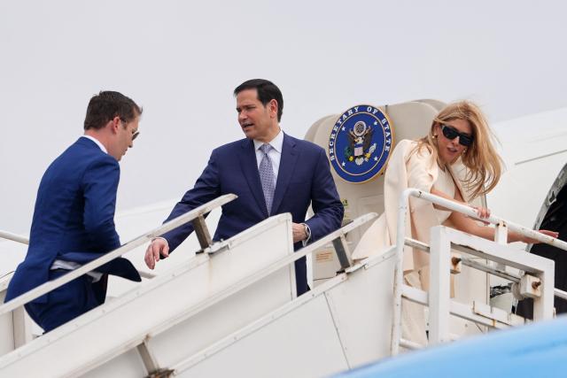 US Secretary of State Marco Rubio (C) gestures to the US Ambassador to India Sergio Gor as they board their plane for New Delhi at Netaji Subhash Chandra Bose International Airport in Kolkata on May 23, 2026. Rubio arrived May 23 on his first trip to India where he will meet Prime Minister Narendra Modi on the heels of US diplomacy with China. (Photo by Julia Demaree Nikhinson / POOL / AFP)
