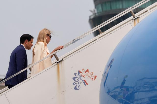 US Secretary of State Marco Rubio and his wife Jeanette board their plane for New Delhi at Netaji Subhash Chandra Bose International Airport in Kolkata on May 23, 2026. Rubio arrived May 23 on his first trip to India where he will meet Prime Minister Narendra Modi on the heels of US diplomacy with China. (Photo by Julia Demaree Nikhinson / POOL / AFP)