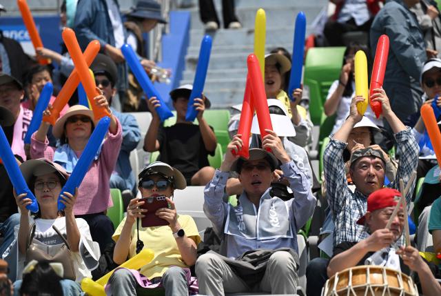 South Korean supporters for North Korea's Naegohyang Women's FC cheer up prior to the AFC Women's Champions League final football match between North Korea's Naegohyang Women's FC and Japan's Tokyo Verdy Beleza in Suwon on May 23, 2026. (Photo by JUNG YEON-JE / AFP)