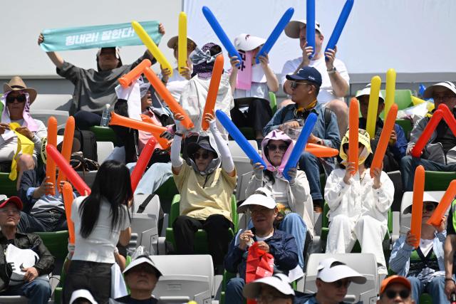 South Korean supporters for North Korea's Naegohyang Women's FC cheer up prior to the AFC Women's Champions League final football match between North Korea's Naegohyang Women's FC and Japan's Tokyo Verdy Beleza in Suwon on May 23, 2026. (Photo by JUNG YEON-JE / AFP)