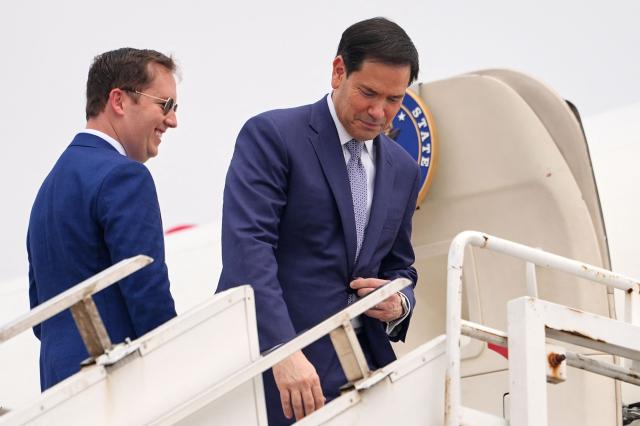 US Secretary of State Marco Rubio (R) talks to the US Ambassador to India Sergio Gor as they board their plane for New Delhi at Netaji Subhash Chandra Bose International Airport in Kolkata on May 23, 2026. Rubio arrived May 23 on his first trip to India where he will meet Prime Minister Narendra Modi on the heels of US diplomacy with China. (Photo by Julia Demaree Nikhinson / POOL / AFP)