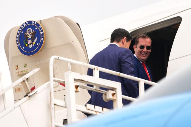 US Secretary of State Marco Rubio (L) and the US Ambassador to India Sergio Gor board their plane for New Delhi at Netaji Subhash Chandra Bose International Airport in Kolkata on May 23, 2026. Rubio arrived May 23 on his first trip to India where he will meet Prime Minister Narendra Modi on the heels of US diplomacy with China. (Photo by Julia Demaree Nikhinson / POOL / AFP)