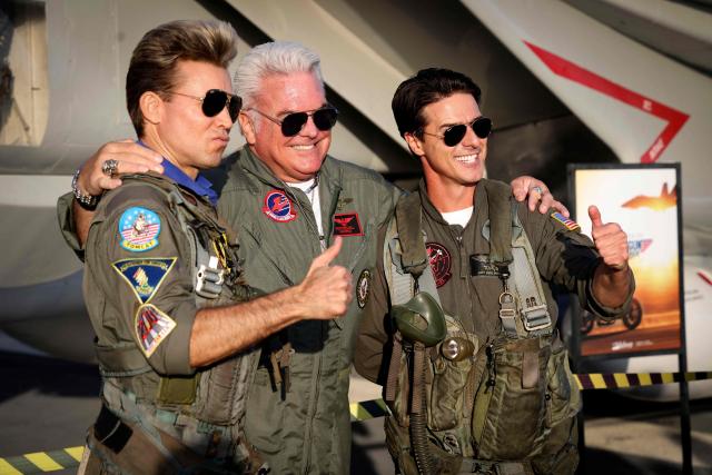 Top Gun impersonators Brian Ernst, "Iceman" and Jerome LeBlanc "Maverick" take photos with fans aboard the USS Midway Museum during the Top Gun 40th Anniversary celebration in San Diego, on May 22, 2026. (Photo by SANDY HUFFAKER / AFP)