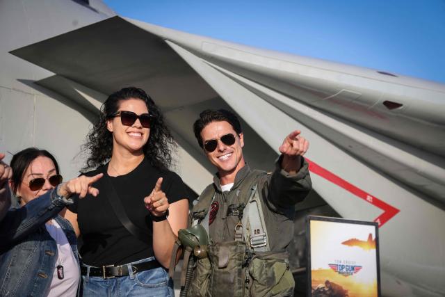 Top Gun impersonator Jerome LeBlanc "Maverick" takes photos with fans aboard the USS Midway Museum during the Top Gun 40th Anniversary celebration in San Diego, on May 22, 2026. (Photo by SANDY HUFFAKER / AFP)