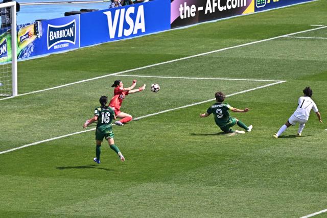 North Korea's Naegohyang Women's FC forward Kim Kyong Yong (R) scores during the AFC Women's Champions League final football match between North Korea's Naegohyang Women's FC and Japan's Tokyo Verdy Beleza at Suwon Sports Complex in Suwon on May 23, 2026. (Photo by Pedro Pardo / AFP)