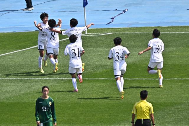 North Korea's Naegohyang Women's FC forward Kim Kyong Yong (L) celebrates with her teammates after scoring during the AFC Women's Champions League final football match betwee North Korea's Naegohyang Women's FC and Japan's Tokyo Verdy Beleza at Suwon Sports Complex in Suwon on May 23, 2026. (Photo by Pedro Pardo / AFP)