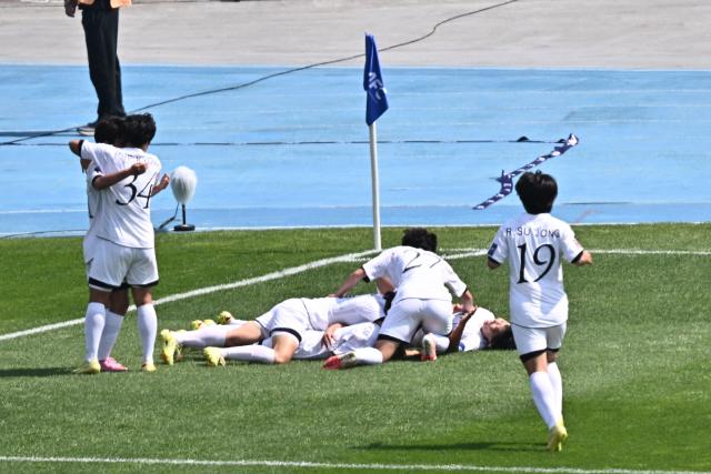 North Korea's Naegohyang Women's FC forward Kim Kyong Yong celebrates with her teammates after scoring during the AFC Women's Champions League final football match betwee North Korea's Naegohyang Women's FC and Japan's Tokyo Verdy Beleza at Suwon Sports Complex in Suwon on May 23, 2026. (Photo by Pedro Pardo / AFP)