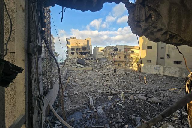 A man looks for his belongings amid debris of a destroyed building at the site of an Israeli strike in the southern Lebanese coastal city of Tyre on May 23, 2026. Two buildings in and around Tyre were struck overnight on May 22 into May 23, after the Israeli military issued an evacuation warning. (Photo by KAWNAT HAJU / AFP)