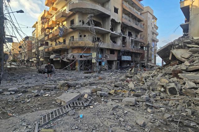 A man inspects the site of an Israeli strike in the southern Lebanese coastal city of Tyre on May 23, 2026. Two buildings in and around Tyre were struck overnight on May 22 into May 23, after the Israeli military issued an evacuation warning. (Photo by KAWNAT HAJU / AFP)