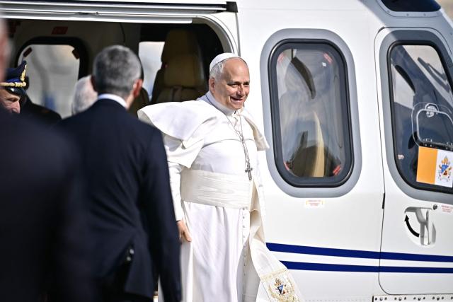 Pope Leo XIV disembarks from the helicopter after landing in Acerra for a pastoral visit to the community of the 'Land of Fires' on May 23, 2026. The Land of Fires (terra dei fuochi) is an area in the Southern Italian region of Campania were, systematically, since the end of the 80s, toxic wastes have been dumped by organized crime (Camorra) causing waste-related environmental crimes. Acerra and the surrounding territory has higher-than-average cancer rates, linked to the dumping, burning, and burying of toxic waste. (Photo by Filippo MONTEFORTE / AFP)