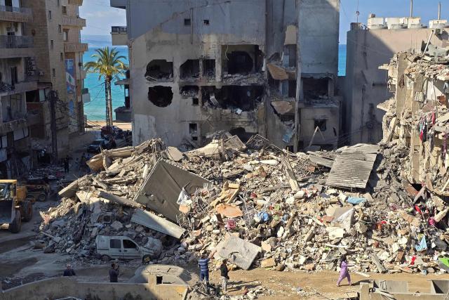 People inspect the site of an Israeli strike in the southern Lebanese coastal city of Tyre on May 23, 2026. Two buildings in and around Tyre were struck overnight on May 22 into May 23, after the Israeli military issued an evacuation warning. (Photo by KAWNAT HAJU / AFP)