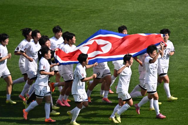 North Korea's Naegohyang Women's FC players celebrate after defeating Japan's Tokyo Verdy Beleza in the AFC Women's Champions League final at Suwon Sports Complex in Suwon on May 23, 2026. (Photo by Pedro Pardo / AFP)