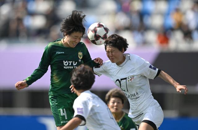 Jo Kuk Hwa (R) of Naegohyang Women's FC fights for the ball with Mayo Doko (L) of Tokyo Verdy Beleza during the AFC Women's Champions League final football match between North Korea's Naegohyang Women's FC and Japan's Tokyo Verdy Beleza in Suwon on May 23, 2026. (Photo by Jung Yeon-je / AFP)
