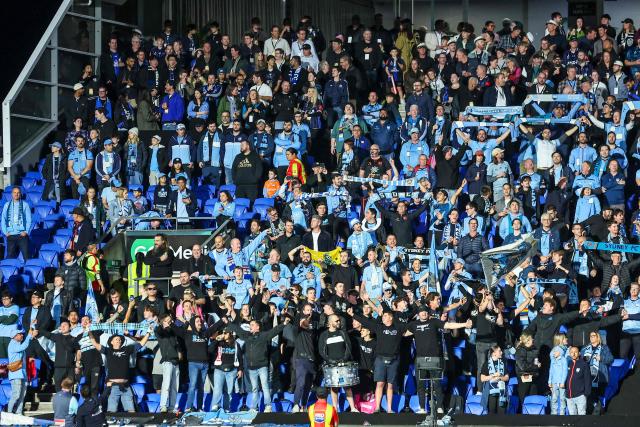 Sydney FC supporters cheer their team during the A League Grand final football match  between Auckland FC and Sydney FC at Go Media Stadium in Auckland on May 23, 2026. (Photo by DJ MILLS / AFP)