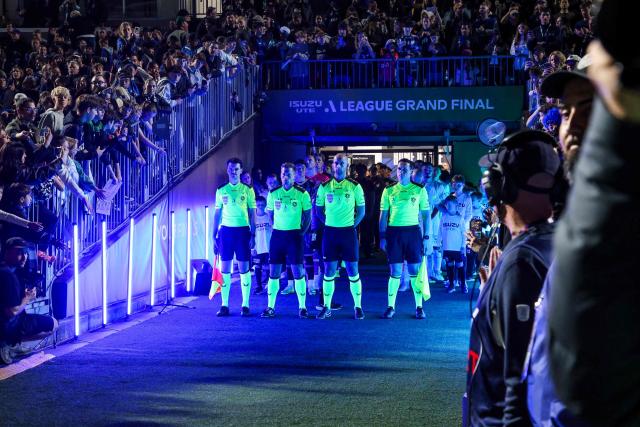 Match officials and players walk out during the A League Grand final football match  between Auckland FC and Sydney FC at Go Media Stadium in Auckland on May 23, 2026. (Photo by DJ MILLS / AFP)