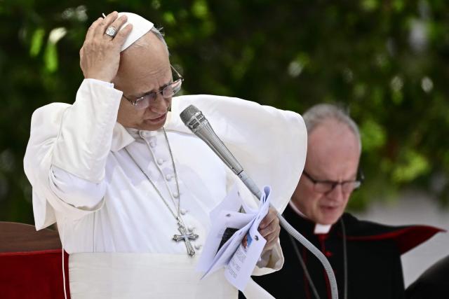 Pope Leo XIV addresses the crowd at Piazza Nicola Calipari during a pastoral visit to the community of the 'Land of Fires' on May 23, 2026. The Land of Fires (terra dei fuochi) is an area in the Southern Italian region of Campania were, systematically, since the end of the 80s, toxic wastes have been dumped by organized crime (Camorra) causing waste-related environmental crimes. Acerra and the surrounding territory has higher-than-average cancer rates, linked to the dumping, burning, and burying of toxic waste. (Photo by Filippo MONTEFORTE / AFP)