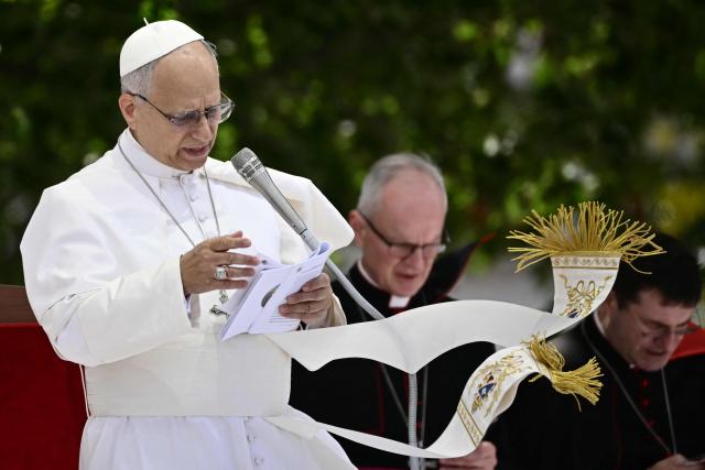 Pope Leo XIV addresses the crowd at Piazza Nicola Calipari during a pastoral visit to the community of the 'Land of Fires' on May 23, 2026. The Land of Fires (terra dei fuochi) is an area in the Southern Italian region of Campania were, systematically, since the end of the 80s, toxic wastes have been dumped by organized crime (Camorra) causing waste-related environmental crimes. Acerra and the surrounding territory has higher-than-average cancer rates, linked to the dumping, burning, and burying of toxic waste. (Photo by Filippo MONTEFORTE / AFP)