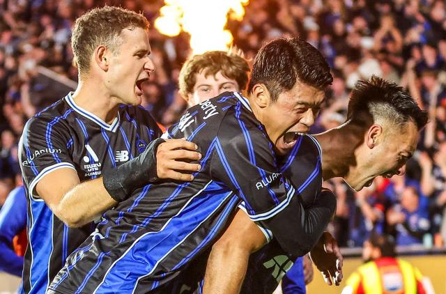 Auckland FC's Cameron Howieson (R) celebrates a goal with teammates during the A League Grand final football match between Auckland FC and Sydney FC at Go Media Stadium in Auckland on May 23, 2026. (Photo by DJ MILLS / AFP)