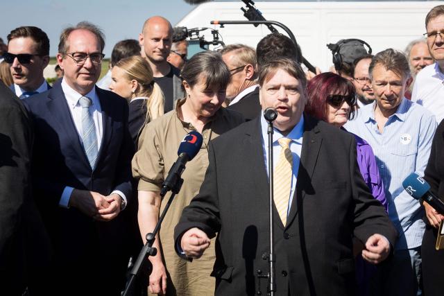 German Interior Minister Alexander Dobrindt (2nd L) listens as Bernd Posselt (C), chairman of the "Union of Expellees within the Christian Social Union party" (UdVA, Union der Vertriebenen, Aussiedler und Deutschen Minderheiten der CSU), speaks during an event to commemorate the flight and expulsion of Sudeten Germans during and after World War II, on May 23, 2026 in Pohorelice, South Moravia, Czech Republic. (Photo by Radek MICA / AFP)