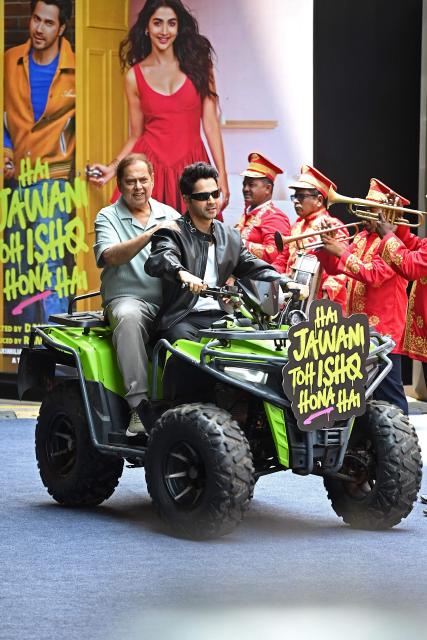 Bollywood film director David Dhawan (L) with his son and actor Varun Dhawan  arrives to attend the trailer launch of their upcoming Indian Hindi-language romantic comedy film 'Hai Jawani Toh Ishq Hona Hai' in Mumbai on May 23, 2026. (Photo by Sujit JAISWAL / AFP)